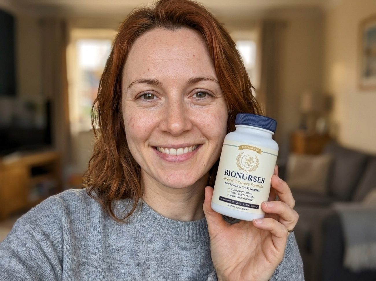 Rachel, happy and well-rested, holding a bottle of BioNurses next to her face at home